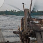 Chinese fishing nets hanging on a boat in kochi seas side- Places to visit in south Kerala