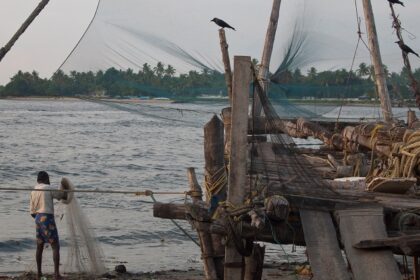 Chinese fishing nets hanging on a boat in kochi seas side- Places to visit in south Kerala