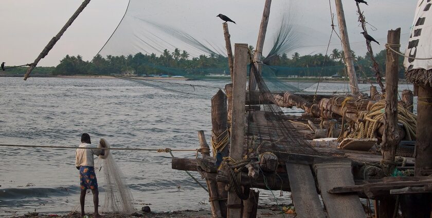 Chinese fishing nets hanging on a boat in kochi seas side- Places to visit in south Kerala