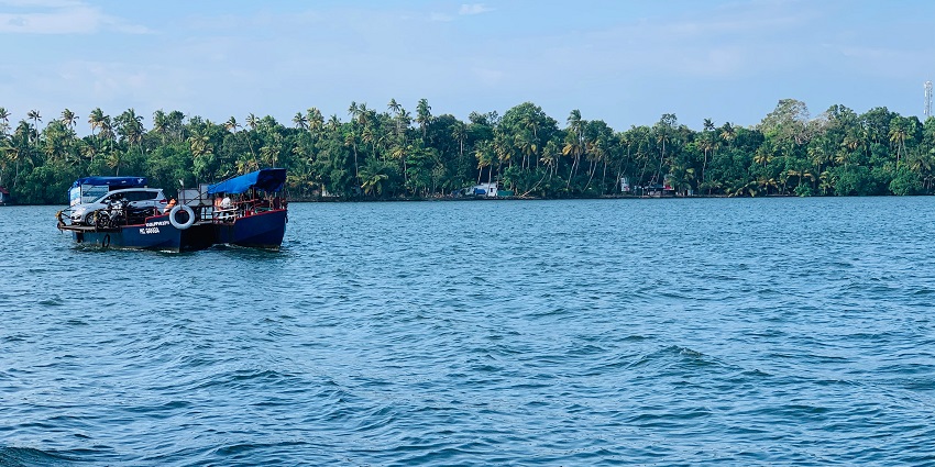 A glimpse of a boat sailing on the shimmering blue waters in Munroe Island, Kollam.