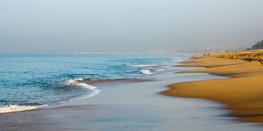 Relax and unwind at Kollam Beach with sunset views and local snacks along the shore.