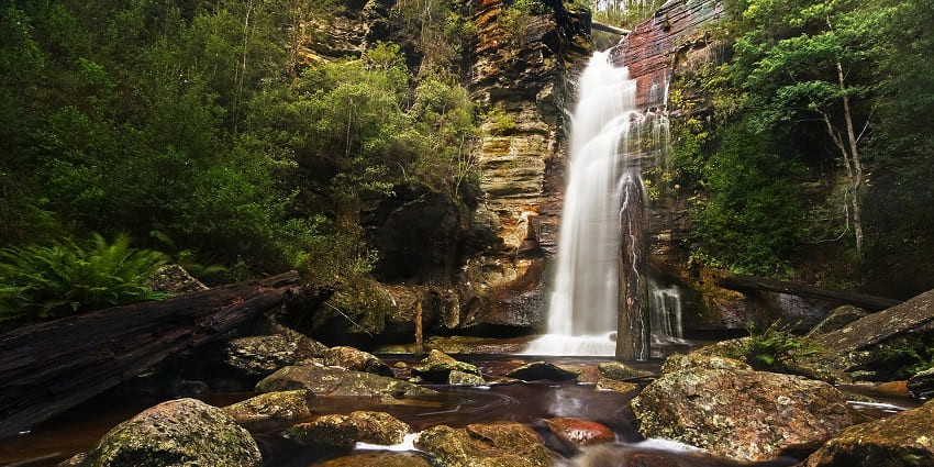 An image of a cascading crystal white waterfall, similar to Kottathavalam Waterfalls