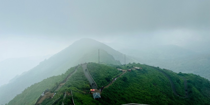 A serene glimpse of the majestic mountains and lush green vegetation of Kottayam.