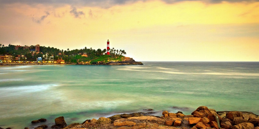 A panoramic view of a lighthouse in Kovalam which is surrounded by glistening waters