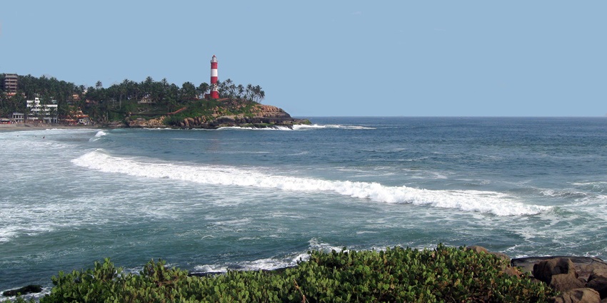 Admire the blue hues of the skyline intersecting the sparkling shores of Kovalam Beach