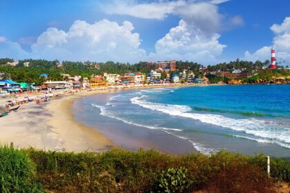 A scenic glimpse of azure waters hitting the sandy shores at Kovalam Beach in Kerala.