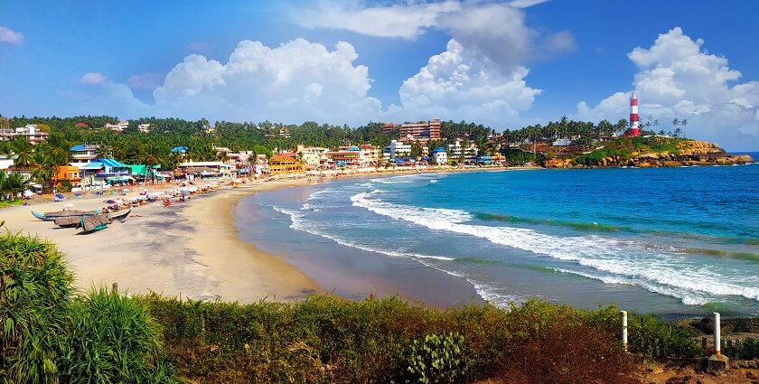 A scenic glimpse of azure waters hitting the sandy shores at Kovalam Beach in Kerala.