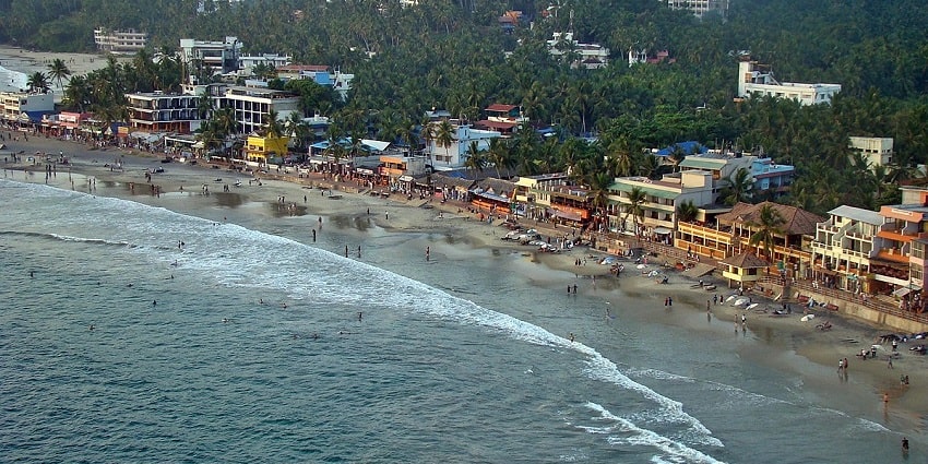 Waves crashing at the golden shores of Kovalam beach- a serene sight for tourists