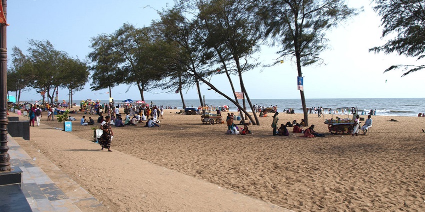 The view of Kozhikode Beach and people enjoying the golden sands and gentle waves.