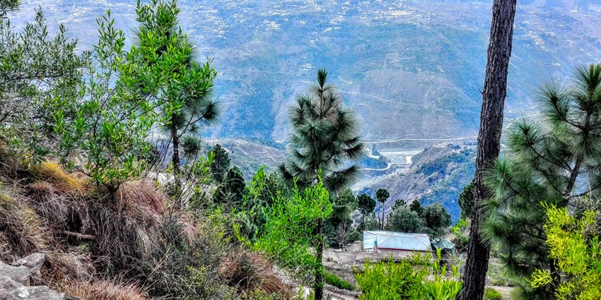 A serene mountain landscape with greenery and must see in places to visit near Patnitop.