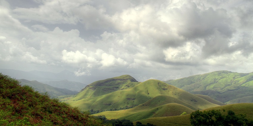 Lush green landscapes with rolling hills and serene views - hill stations near Kerala