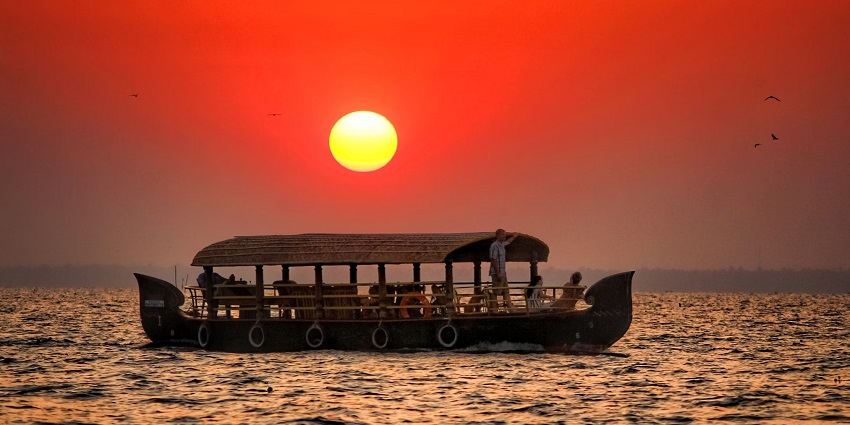 Enjoy stunning sunset views from a houseboat with places to visit in Kerala in January