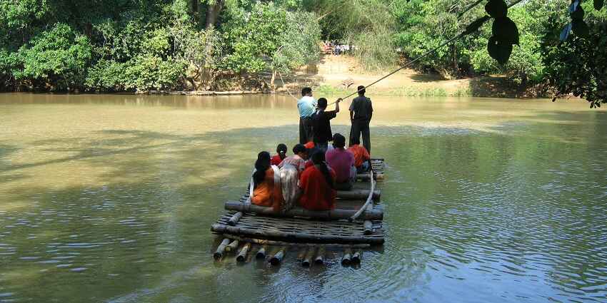 Scenic views of Kuruva Island with dense greenery and serene waterways people travelling