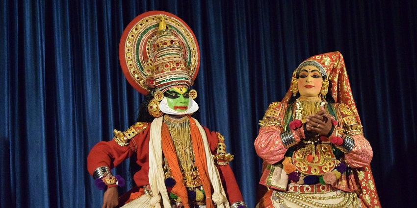 Performers in vibrant costumes on stage for the famous Kuthiyottam Dance of Kerala