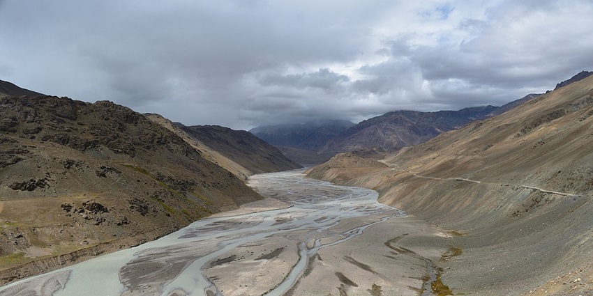 A dried up river bed between a valley