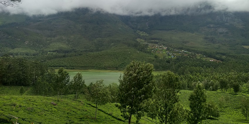 The view of tea hills, a lake and clouds at the Echo Point of Munnar in Kerala, India.