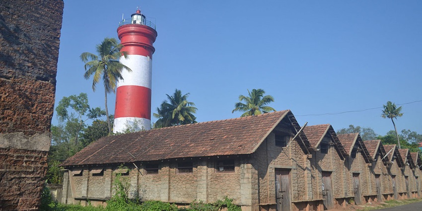 Historic Lighthouse of Alleppey standing tall against a backdrop of clear blue skies.