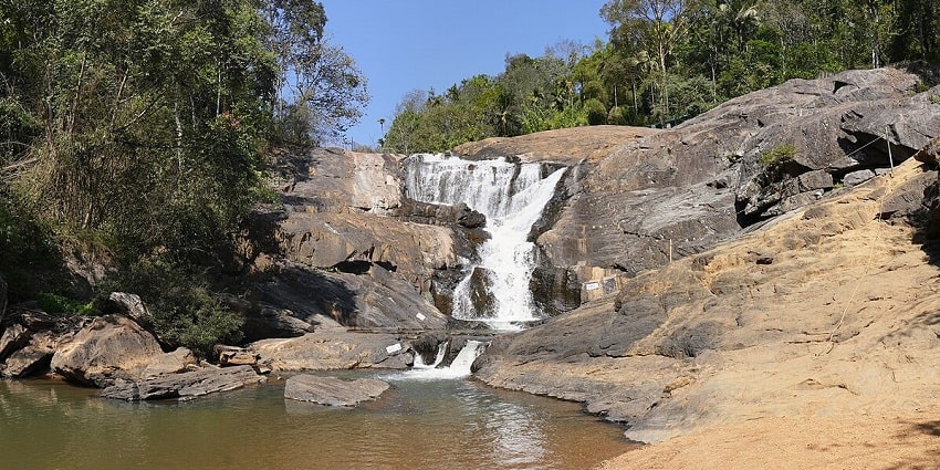 A stunning view of Kanthanpara Waterfalls with free-flowing water over the rocks.