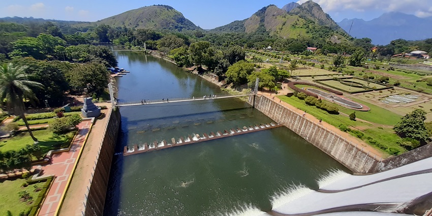 Wide aerial view of Malampuzha Dam reservoir with gardens–places to visit in kerala in november