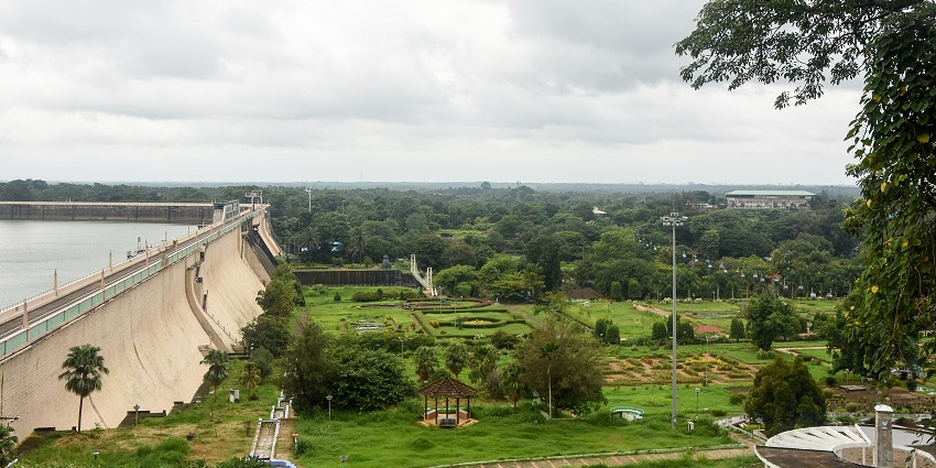 A breathtaking view of Malampuzha Garden & Dam with a backdrop of verdure and cloudy skies