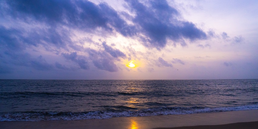 Palm-fringed Marari Beach with clean sands, calm waters, and a laid-back tropical vibe.