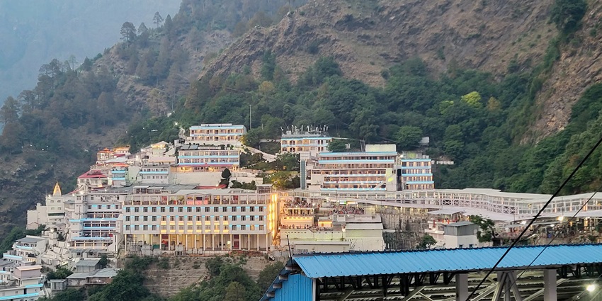 View of the sacred Vaishno Devi Bhawan decorated with colourful lights amidst mountains