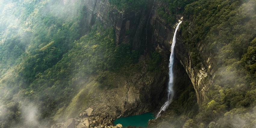 An aerial view of a waterfall in the mountains - best places to visit in north east India