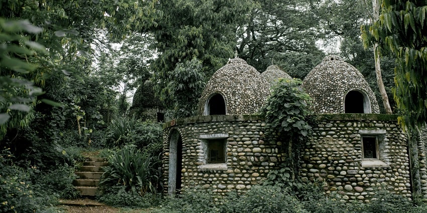The view of old stone Buddhist meditation house in green garden - places to visit in Aluva