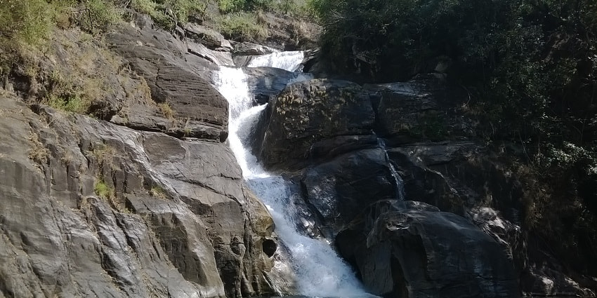 Water cascading down the rocks of Meenmutty Falls located near the Banasura Sagar dam