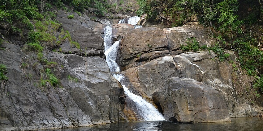 See the breathtaking views of Meenmutty Waterfalls - a place to visit in Kerala in April.