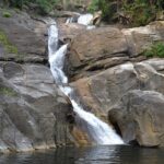 Experience the beautiful Meenmutty Waterfalls located in serene Wayanad, Kerala, India.