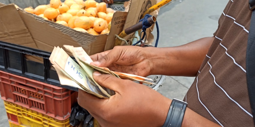 An image of a man calculating cash—the cost of scuba diving in the Andaman Islands