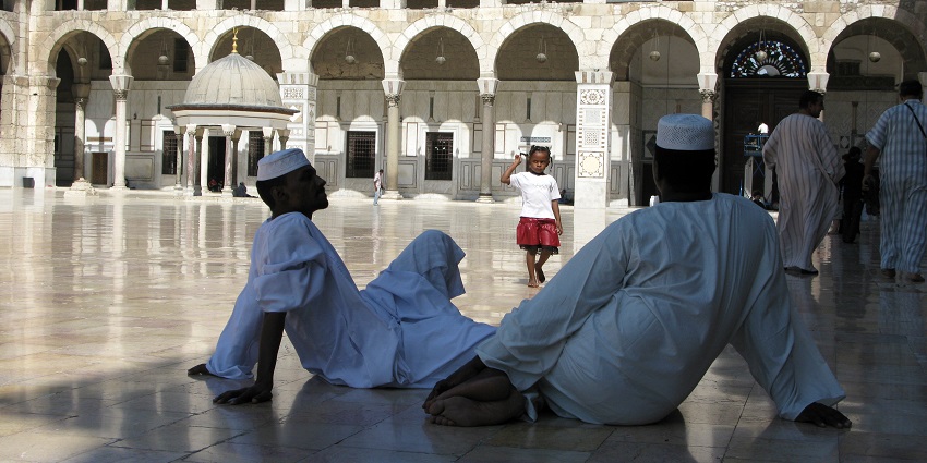People sitting in a hall at a mosque