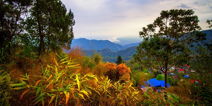 Expansive views of the Himalayas from Latpanchar, lush greenery landscape clear blue sky.