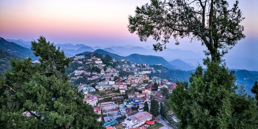 An aerial shot of the charming Mall Road in Mussoorie with the clouds in the backdrop