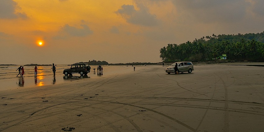 Beachgoers driving their cars along the iconic Muzhappilagad drive-in Beach in Kannur