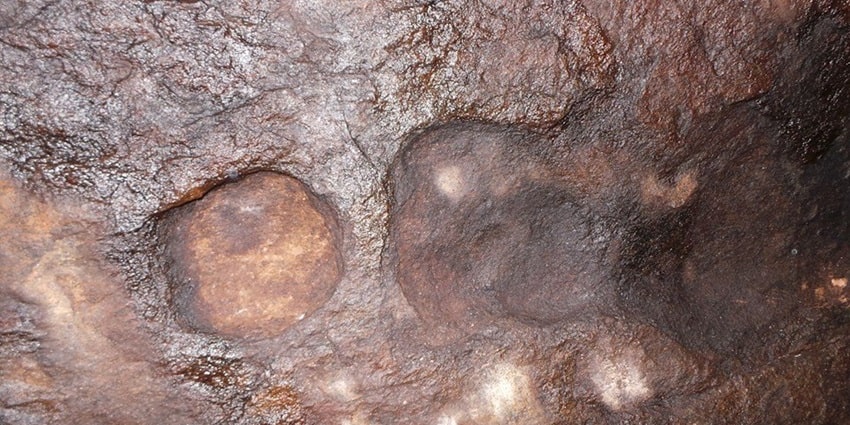 A unique picture of elaborate petroglyphs on cupules found at the Nedumala Caves in Kerala