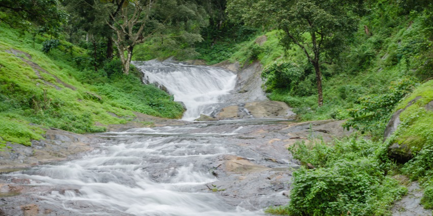 Mesmerising view of sparkling water streaming down the rocks of Nelliyampathy hills
