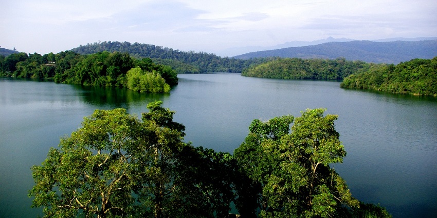 Neyyar Dam in Thiruvananthapuram, surrounded by lush greenery and tranquil waters.