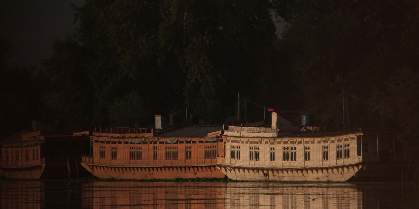 A scenic view of houseboats at Nigeen Lake, which is near the Salim Ali National Park