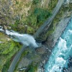 Aerial views of the thrilling waterfall coming down the hill through a vast forest in Idukki