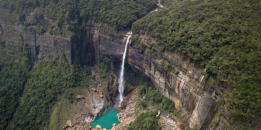 Breathtaking Nohkalikai Falls, plunging from a cliff into a turquoise pool below.
