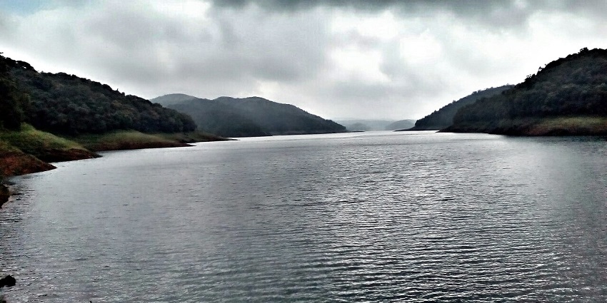 A glistening lake at Painavu in Kottayam with the backdrop of lush mountains