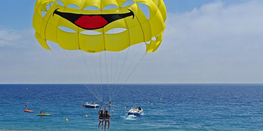 Parasailing soaring high above the sea with stunning coastal views - water sports