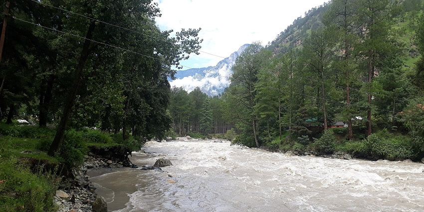 Captivating view of gushing Parvati River surrounded by lush greenery