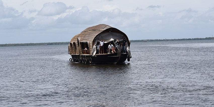 iew of a houseboat surrounded by serene - Places to visit in Alleppey for couples