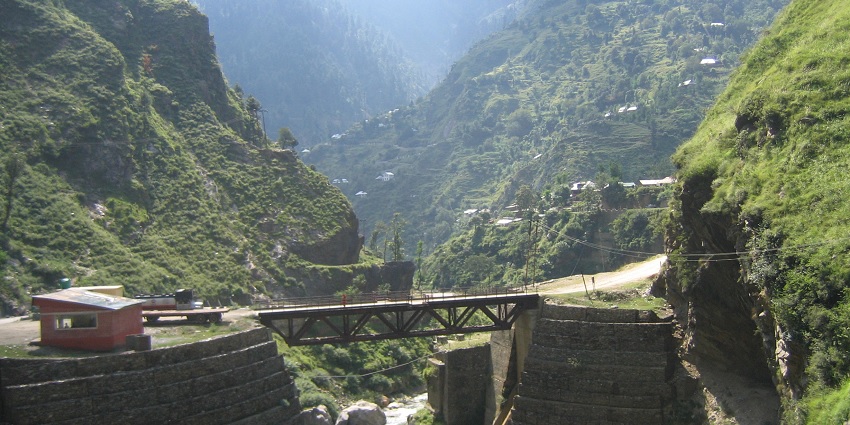 A bridge connecting Patnitop to the Jawahar Tunnel, surrounded by green mountains.