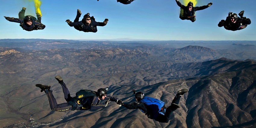 An image of a person undertaking the adventure of skydiving in the middle of the sky.