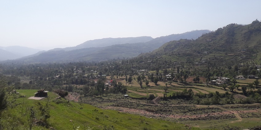 A majestic view of a valley near Hirpora Wildlife Sanctuary with a blanket of lush greenery