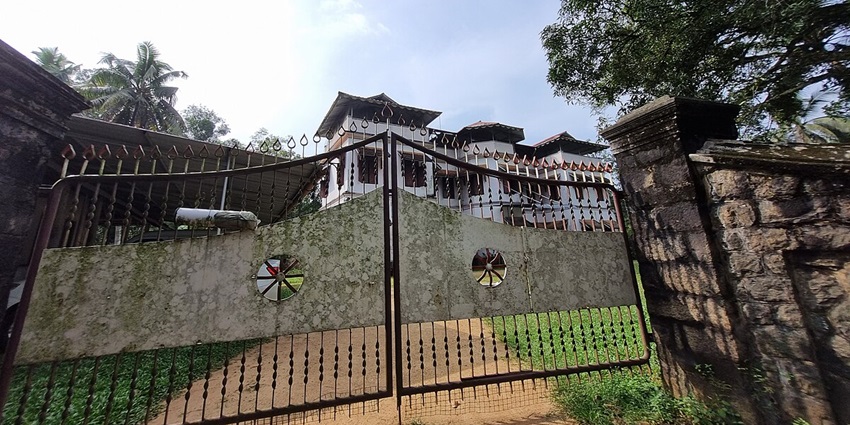 Poonjar Palace showcasing traditional Kerala architecture with intricate wooden carvings.